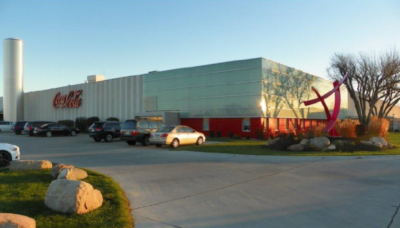 The Chesterman Company building with cars out front and large red letters saying Coca Cola.