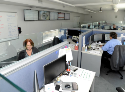 Lincoln Computer Services office showing multiple cubicles with employees at their desks working.