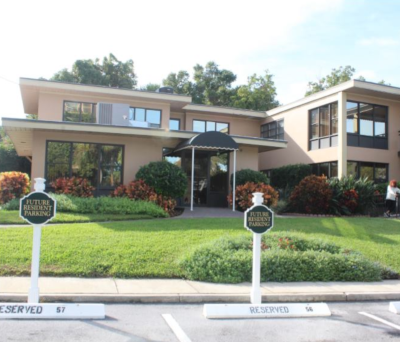 The Oaks of Clearwater, view of the office from the parking lot, with reserved for future residents signs on parking spots.