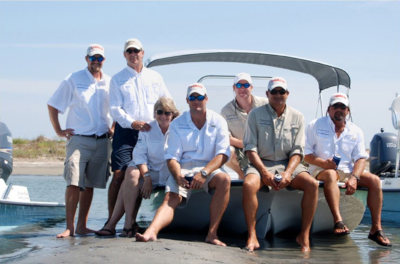 The Sportsman. A group of people sit on the front of a Sportsman boat for a photo.