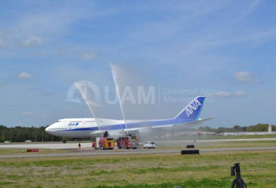 Universal Asset Management working on a jumbo jet on the runway.