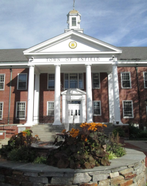 Enfield Connecticut, A brick building with white pillars in front and Town Of Enfield with the city seal above that on the front.