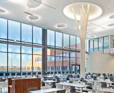 Interior of a large building with desks and a high ceiling with circular lighting accents in St. Catharines Ontario.