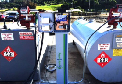 SCI Distribution. Two tanks with flammable hazard labels and a controller in the middle of the two tanks.