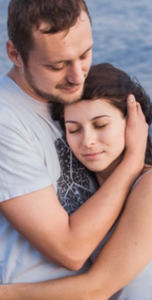 American Addiction Treatment Association. A man holds his wife's head as she lays it against hist chest.