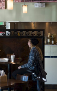 Taziki’s Mediterranean Café. A patron seated at a table.