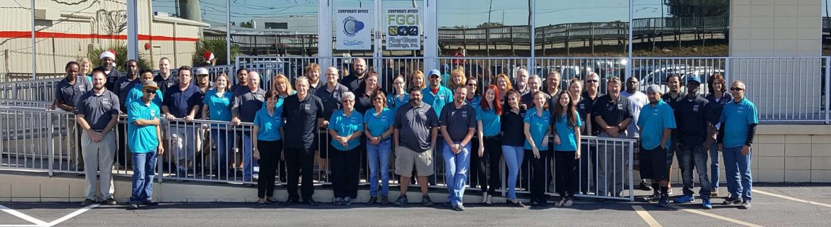 Group shot of Fiberglass Coatings Inc. employees out front of one of their buildings.