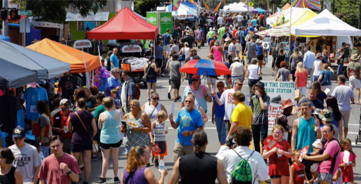 Hopkinsville Kentucky, a crowd of people at an event, walking up and down the street with vendor tents on both sides.