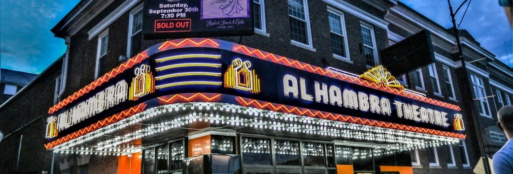 Hopkinsville Kentucky, the outside of the Alhambra Theatre at dusk with neons lights on.