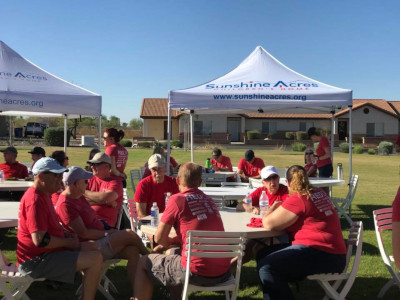 Keller Williams Realty Phoenix at Red Day for Sunshine Acres. People eating outside with tents.