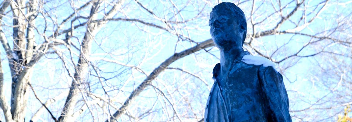 Coventry Connecticut, the upper part of a statue with leafless branches behind in view.
