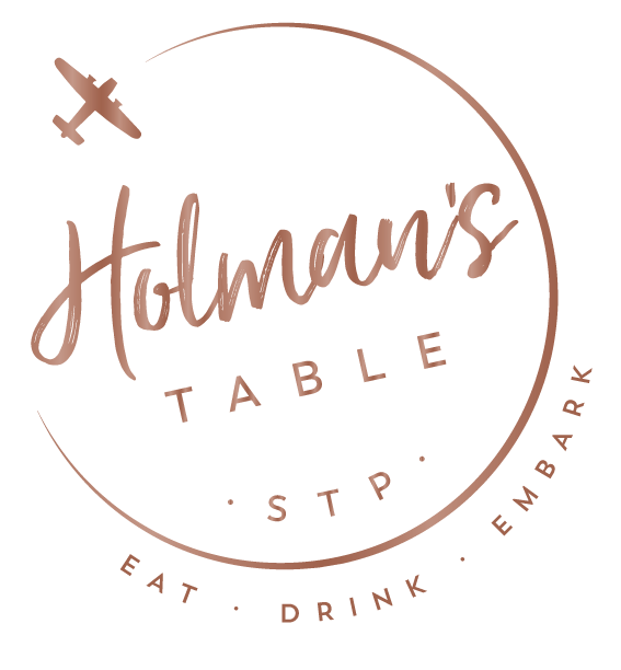 Holman's Table logo. STP. Eat, Drink, Embark.