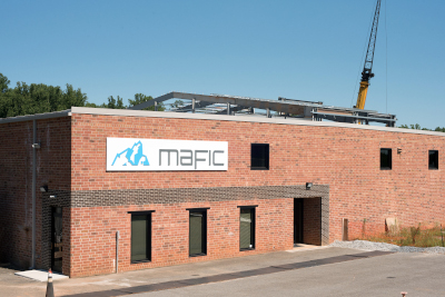 Mafic building with crane in background behind.