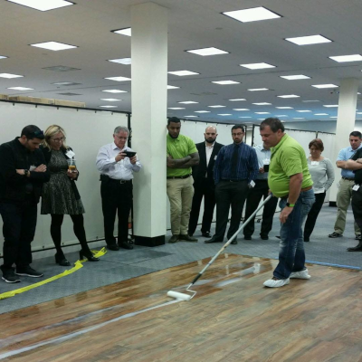 milliCare floor cleaning with people standing around watching.