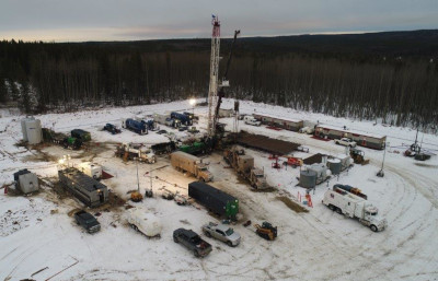 Perpetual Energy work site with work vehicles parked in the snow.