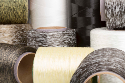 Innegra Technologies. Multiple spools of fiber thread in varying colors.
