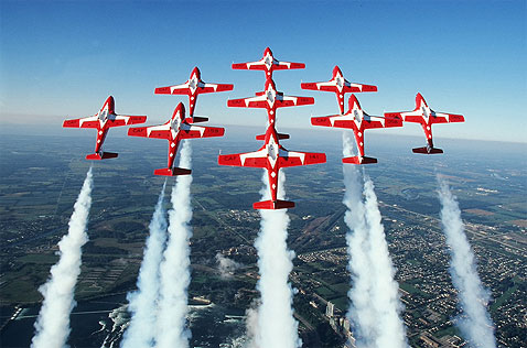 Moose Jaw Saskatchewan Snowbirds in a diamond formation with smoke trailing behind them.