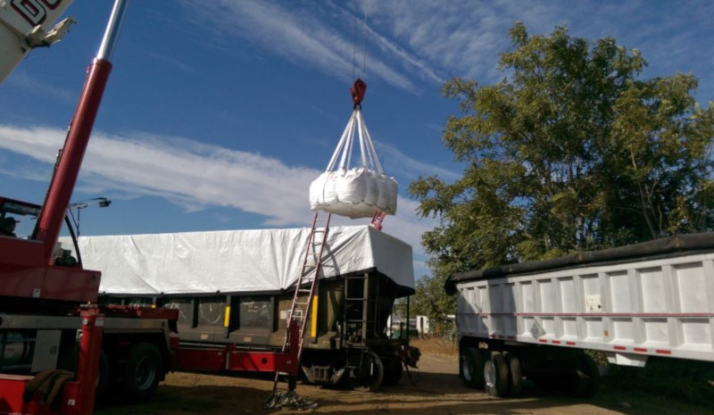 I.C.E Service Group, loading or unloading a railroad card with a crane and truck nearby.