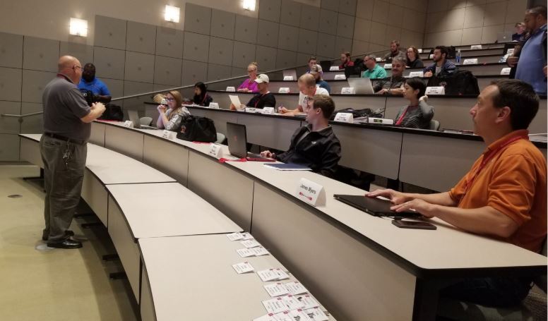 Investment Casting Institute lecture hall with people and name badges.