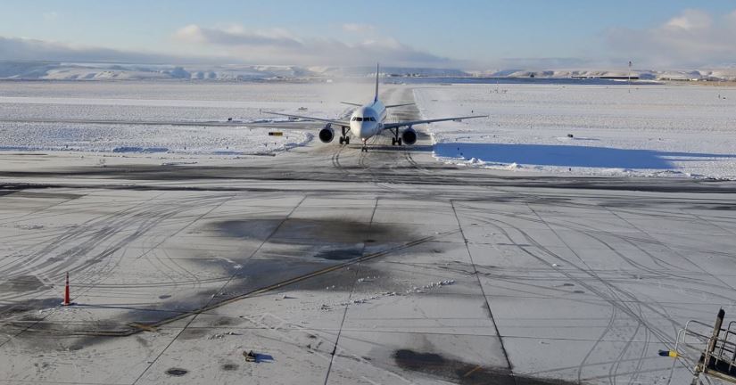 Lewiston-Nez Perce County Regional Airport, commercial jet taxiing in on a snowy runway.