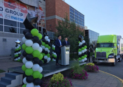 Sault St Marie, Ontario. Event with two men speaking at a podium with balloon displays around the stage.