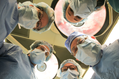 Ely-Bloomenson Community Hospital people in scrubs looking down.