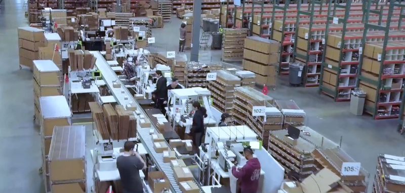 Enlinx workers at work in a large warehouse.