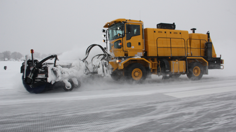 Yakima Air Terminal snow removal vehicle at work on the runway.