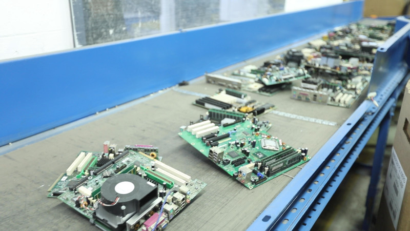 Allocco Recycling and GreenChip. Conveyor belt with electronic components on it.