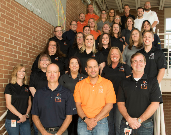 Five Star Call Centers team photo with employees standing on stairs.