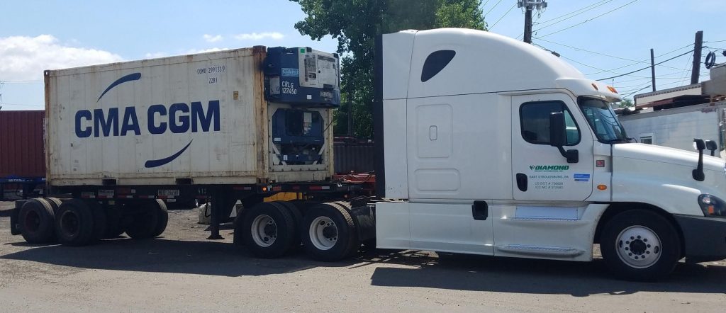 A Semi truck and trailer with a refrigerator unit in tow. Diamond Freight Distribution Inc.