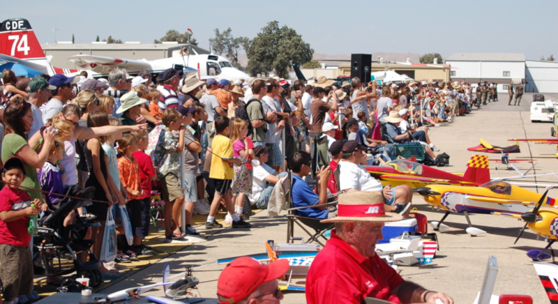 Paso Robles Municipal Airport; a large crows at an airshow with model airplanes on the ground on the right side.