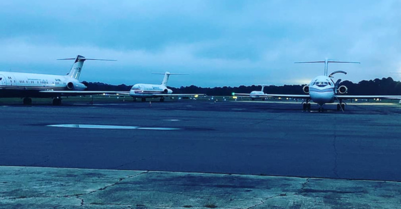 Tuscaloosa Regional Airport runway with jets on the ground, one with the door open.