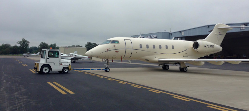 Barkley Regional Airport. A corporate jet being guided by a ground vehicle.