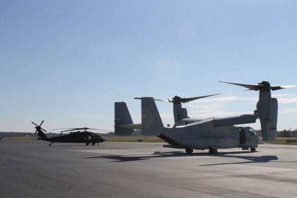 Barkley Regional Airport. A military helicopter and vertical takeoff plane sit on the tarmac.