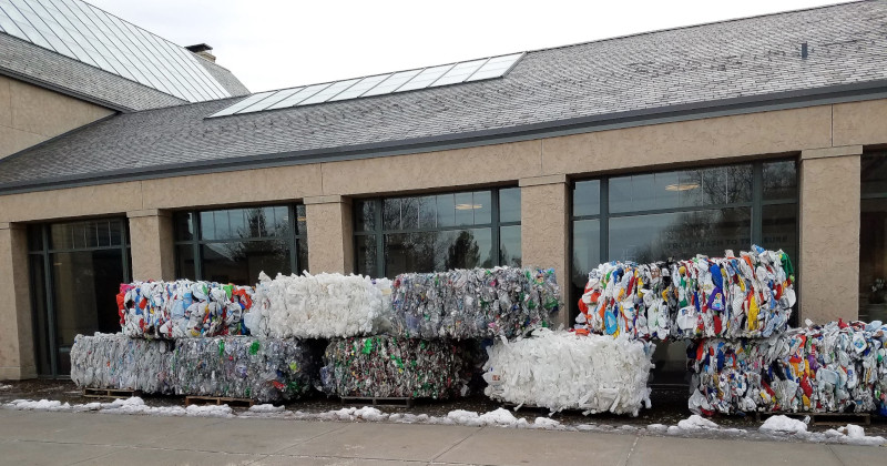 FirstStar Recycling / FirstStar Fiber. Bundles of recycled materials sitting outside of a building.