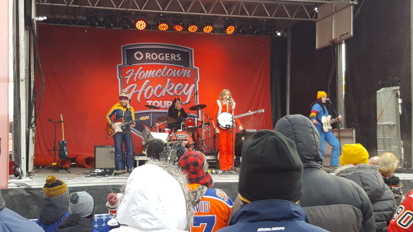 Lacombe, Alberta Hometown Hockey Tour with female musicians on stage performing.