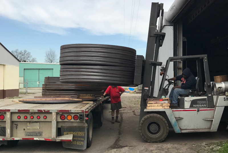 Shamrock Steel forklift loading steel components onto a truck.