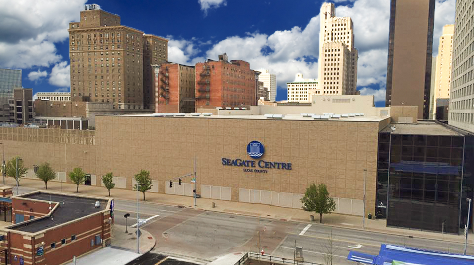 SeaGate Convention Centre, aerial view of the front of the building with blue sky and white clouds behind.