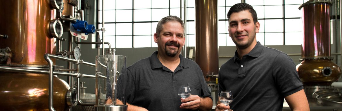 Louisiana Spirits / Bayou Rums Jeff Murphy and Reiniel Vicente at stills with tasting glasses in hand.