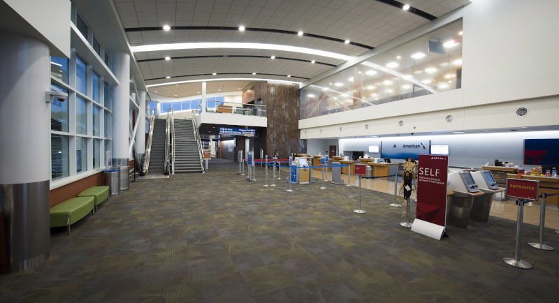 Albert J. Ellis Airport (AOJ) Terminal interior showing check in counters for American Airlines and Delta.