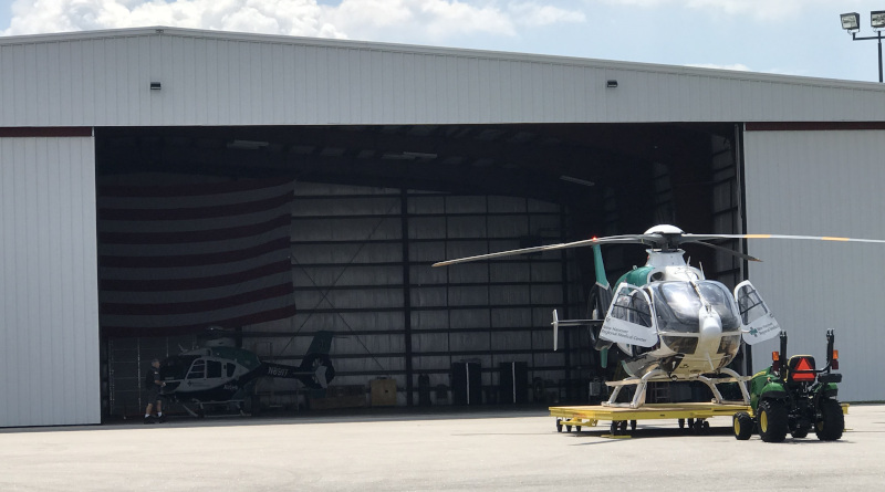 Albert J. Ellis Airport (AOJ) hangar with a helicopter out front.