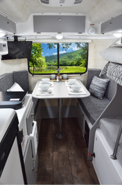 Casita Enterprises Inc., inside of a Heritage trailer showing the kitchen and dining room section.