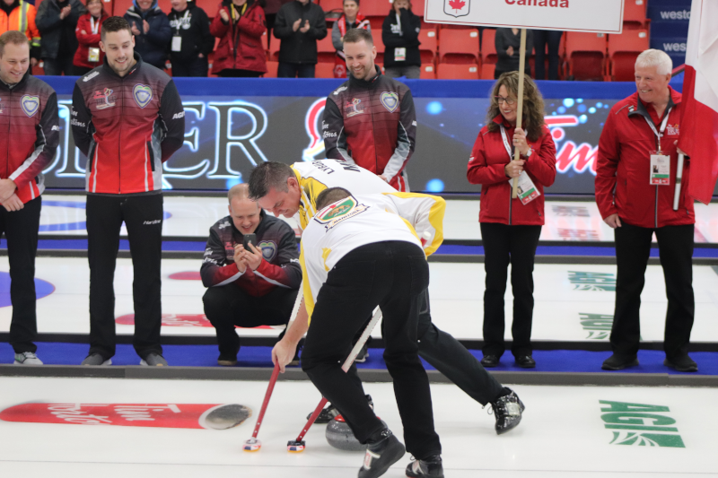 Keystone Centre professional ice curling team in action with bystanders.