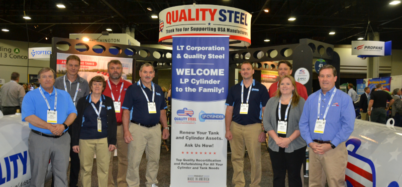 Quality Steel Corporation at a show/even with a booth and a group of people.