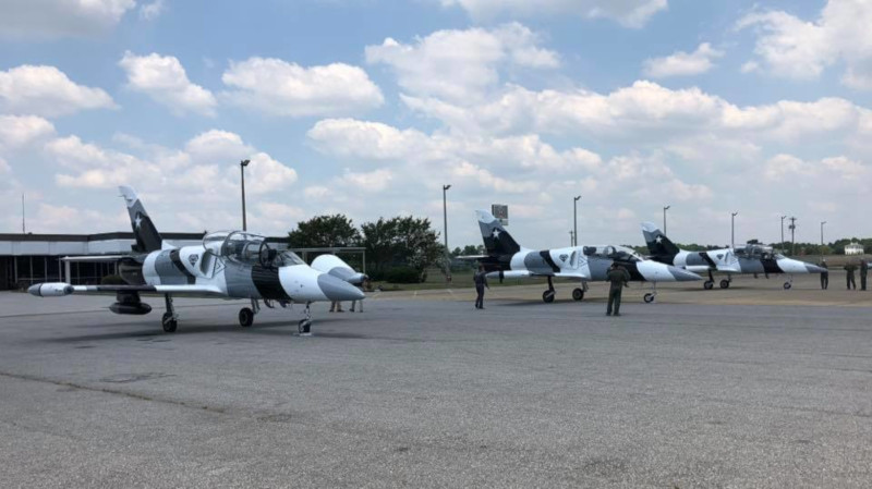 Rocky Mount-Wilson Regional Airport Aerobatic team next to their jets on the tarmac.