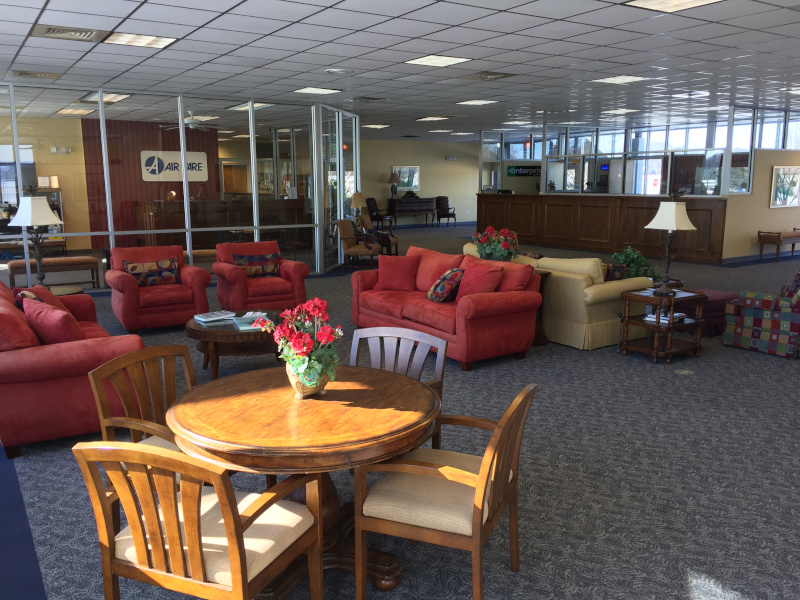 Rocky Mount-Wilson Regional Airport interior showing a waiting area and commercial counters for services like car rental.