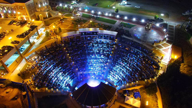 Sugar Hill, Georgia The Bowl aerial view at night with lights shining on the crowd.