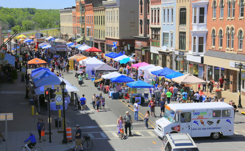 Amsterdam, New York, NY, city street during event with vendor tents and food trucks.