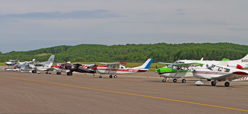 Brainerd Lakes Regional Airport runway showing multiple small aircraft in a row.